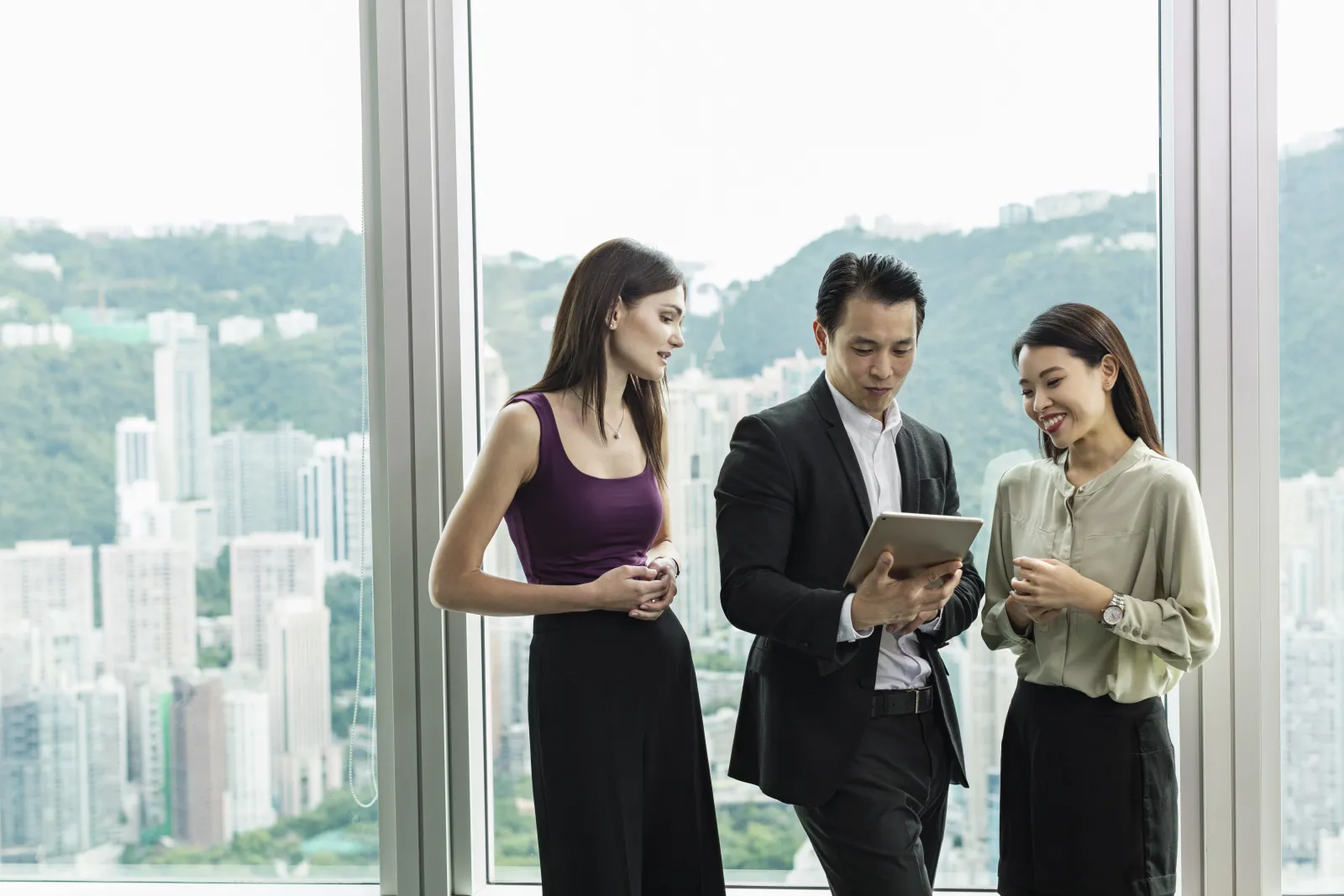 Two colleagues reviewing lending data on a tablet